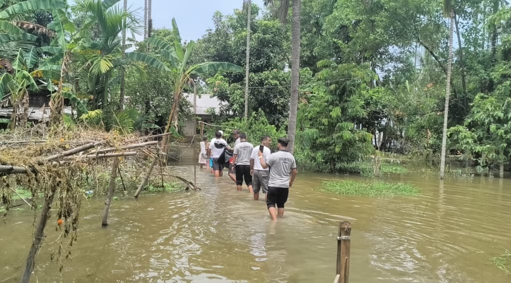 Field Volunteers Navigating Floodwaters